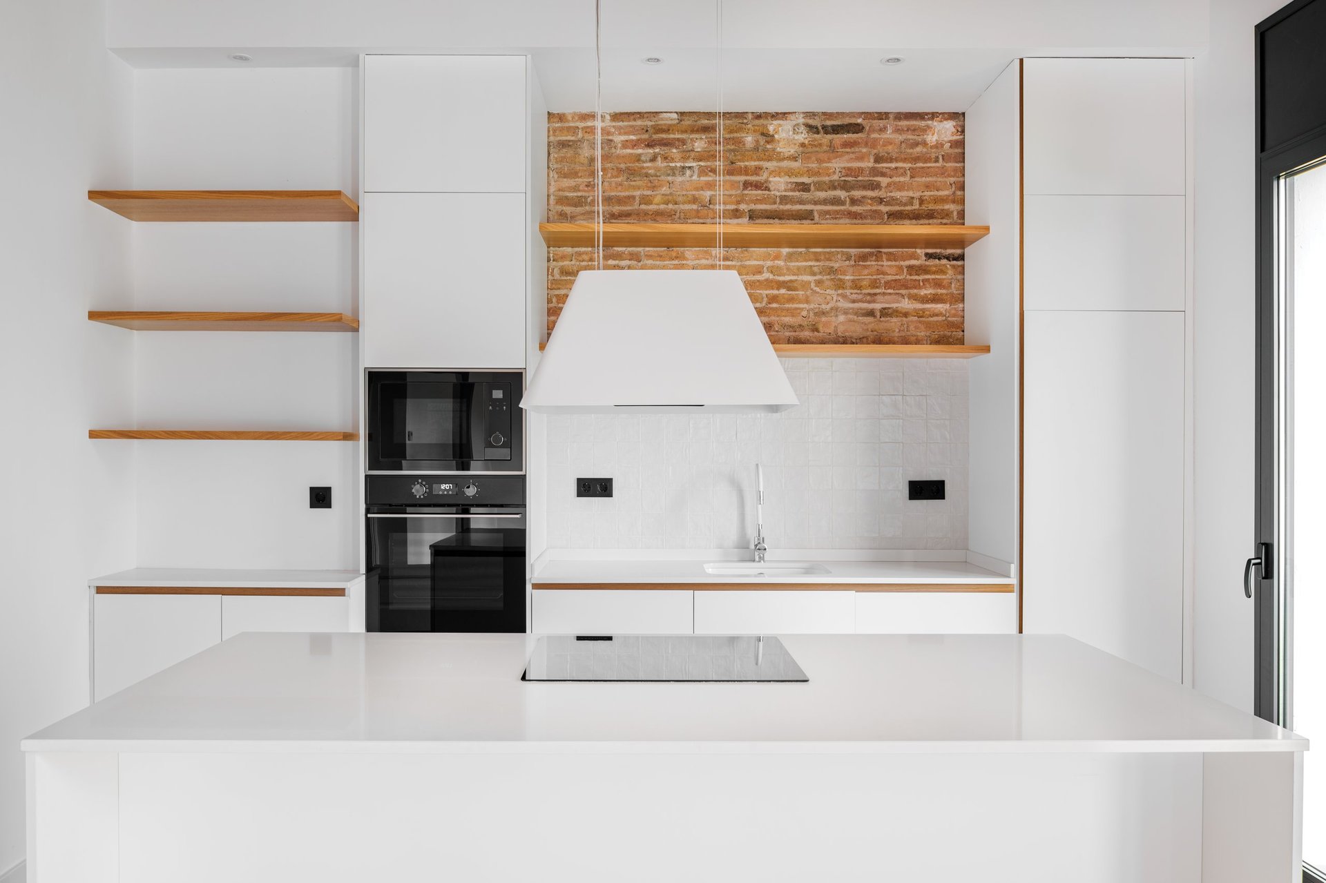 Modern furnished loft apartment with white island kitchen